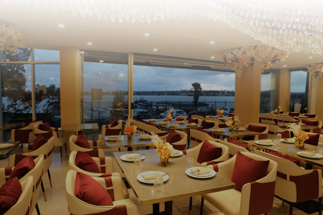 Dining area at 32 Miles Indian Restaurant, offering fine dining with a waterview.